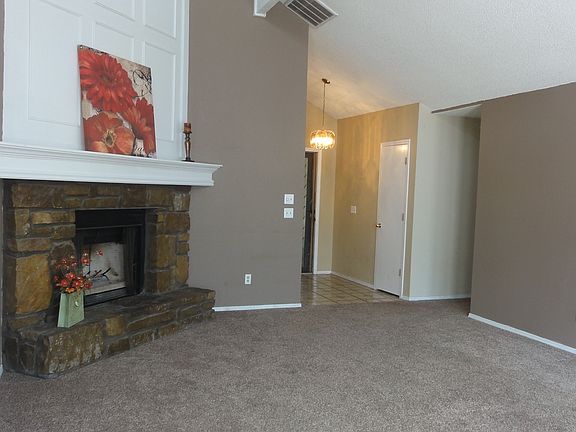 Spacious living with corner fireplace.