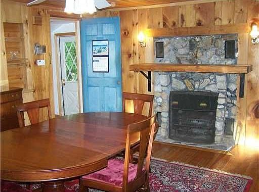 original dining/living area of house with stone fireplace