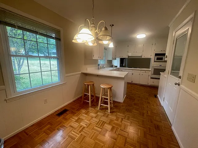 kitchen view with breakfast area (door to double car garage on right)