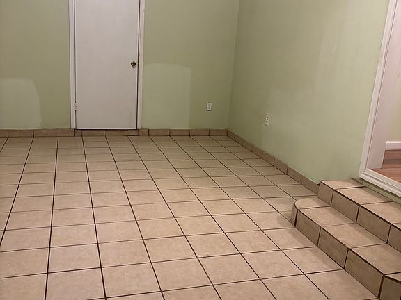 Living room with door to laundry room and back house door