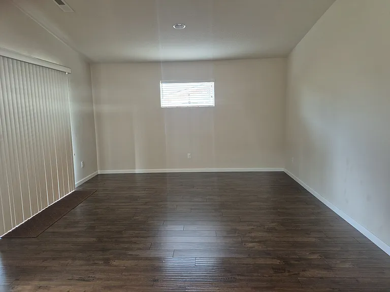 Large dining room in open floor plan with kitchen and living room and sliding doors to patio out back.