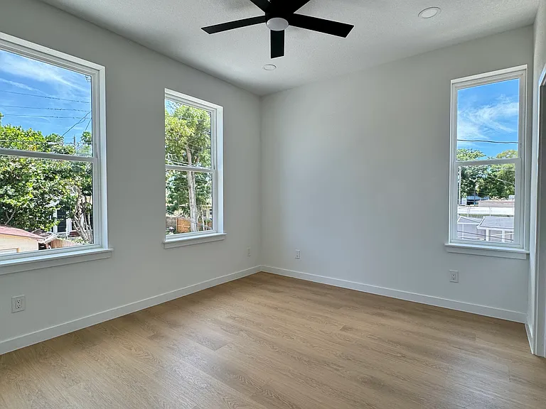 Spacious bedroom with large windows.