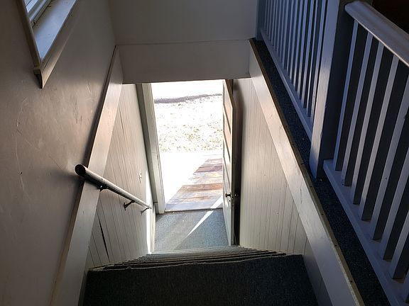 Carpeted interior stairwell.