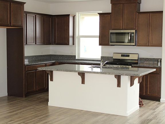 New kitchen complete with microwave over range, dishwasher, pantry and bar seating.