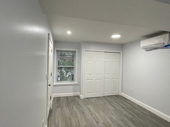 living room. that is not a closet space, it is a hidden electrical/water unit