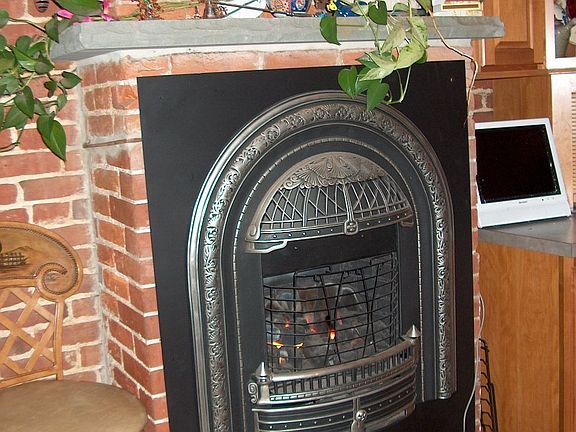 Exposed brick and gas fireplace in the kitchen