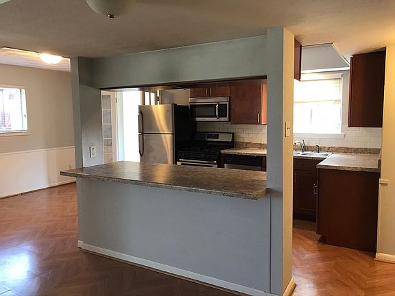 The kitchen includes all stainless steel appliances, custom cabinets, and granite. The window over the sink looks out to the backyard so to watch the kids or animals. There is a unique space surrounding the kitchen for a breakfast area and a dining roo