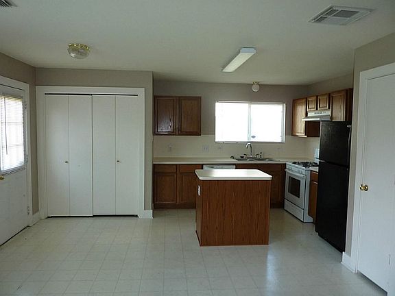 Kitchen with utility closets to the left and pantry to the right