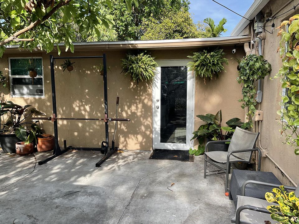 The entrance to the home is right next to the home gym and patio area.