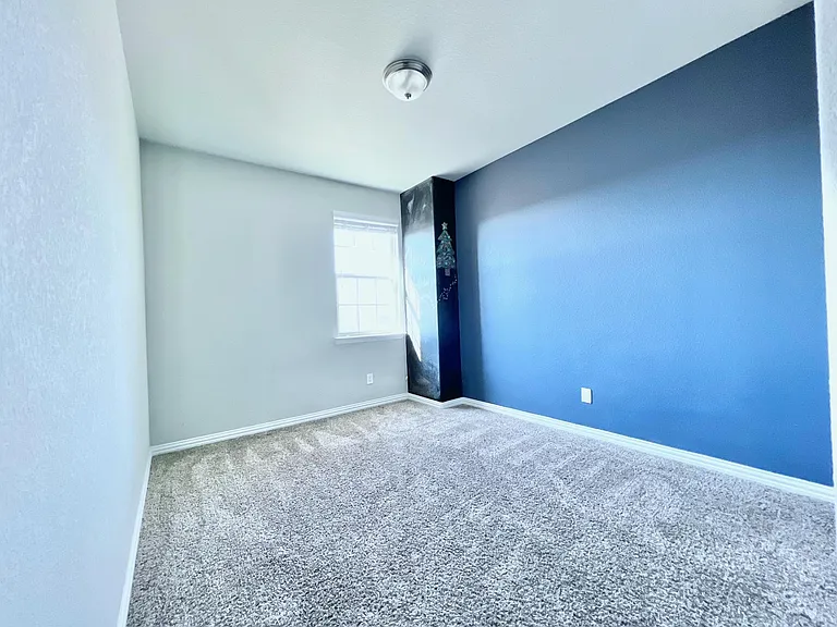 Bedroom #3 upstairs with accent wall having chalk section