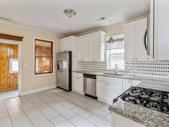 Kitchen enters enclosed back porch
