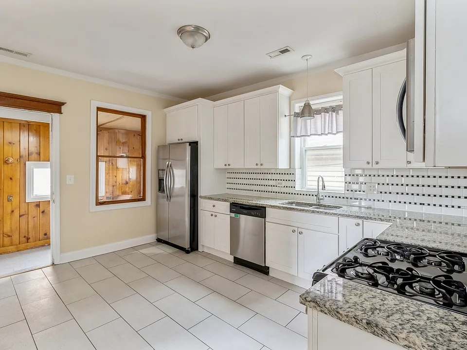 Kitchen enters enclosed back porch