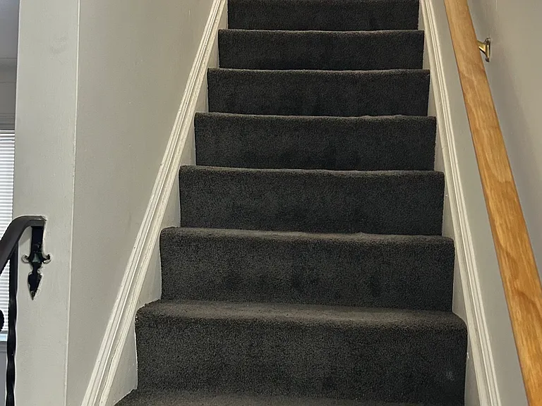 Stairwell leading to upper-level bedrooms, offering separation and privacy.