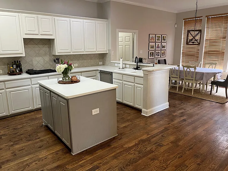 Open kitchen to family room and secondary dining area with gas cooktop