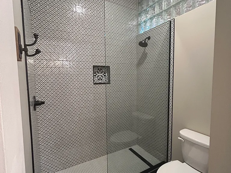 Custom privacy windows allow natural light and privacy for this stunning shower!