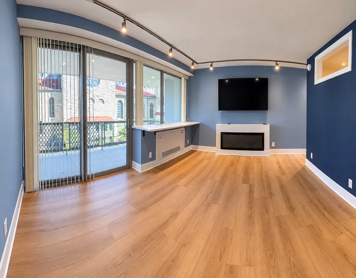 Living room area with 60inch TV and electric remote control fireplace.