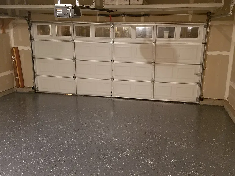 Garage with Epoxy Flooring and Overhead Shelving Racks