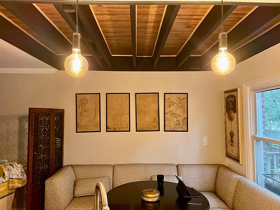 Lifted ceiling with wood beams and wood ceiling. Very tasteful dining area!!