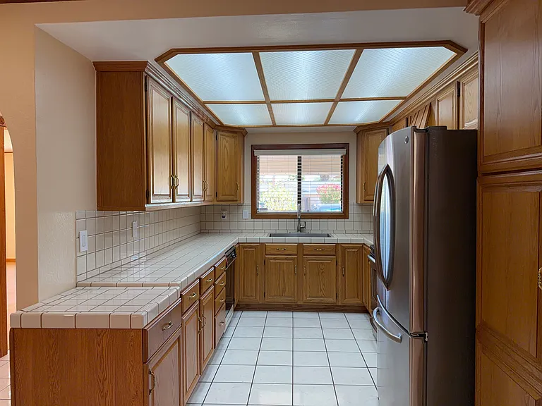 Wrap-around counter space with window over the sink
