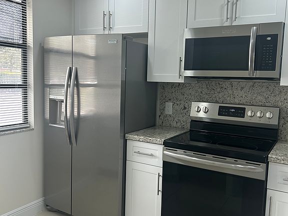newer appliances, refrigerator, microwave, stove, washer Dryer