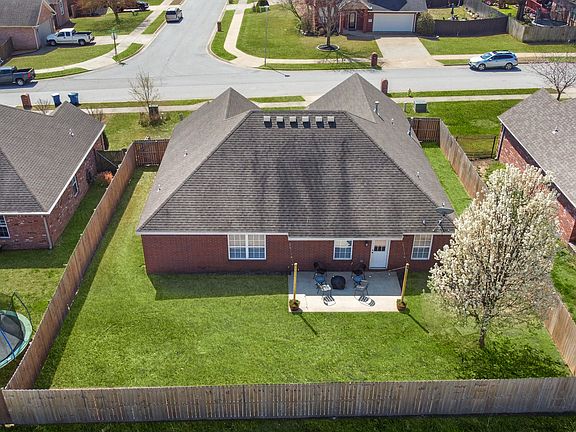 Fenced in yard and backyard features a small patio area - firepit included!