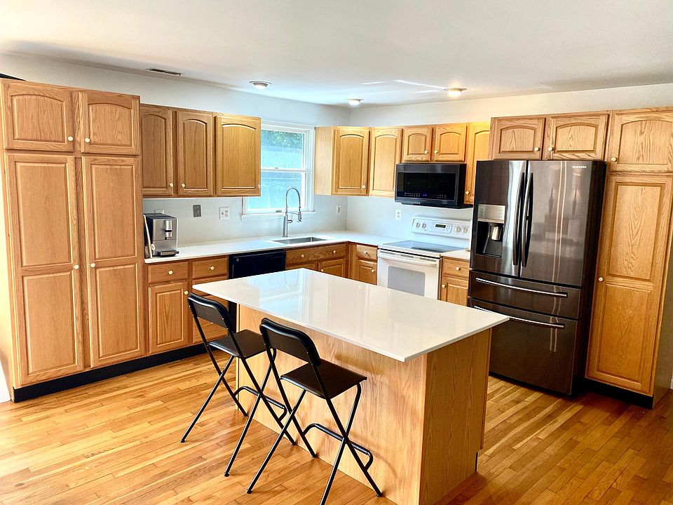 Upper level Open kitchen quartz countertops and oak cabinets
