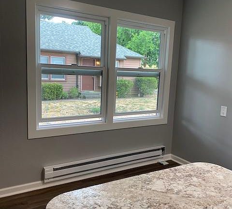 Dining area sits by the window. New window coverings are ordered and should be here soon