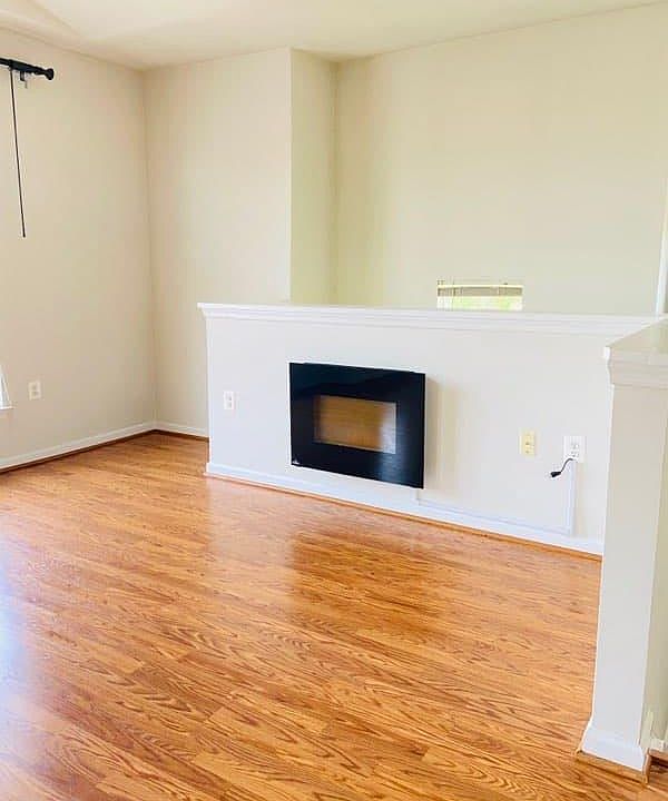 Open Concept living room with fireplace create for a spacious cozy feel