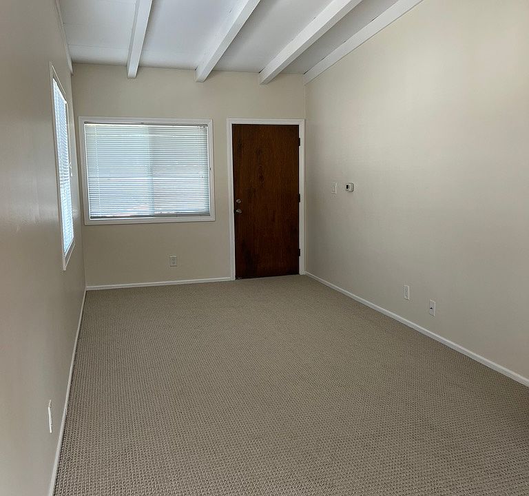 Living room updated with new paint and carpet.