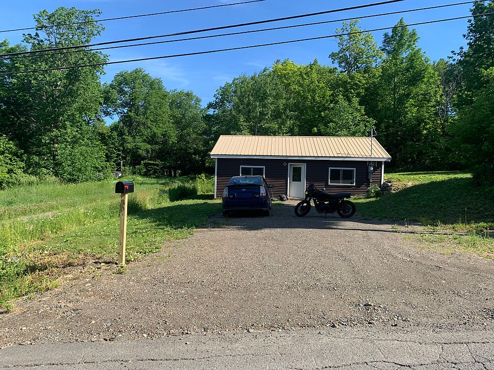 My house when I first moved in. Just bought a Boston ivy, to grow over the sides of the house and will either place another black room over the old one or paint the current one black in the future (light brown was not my choice).