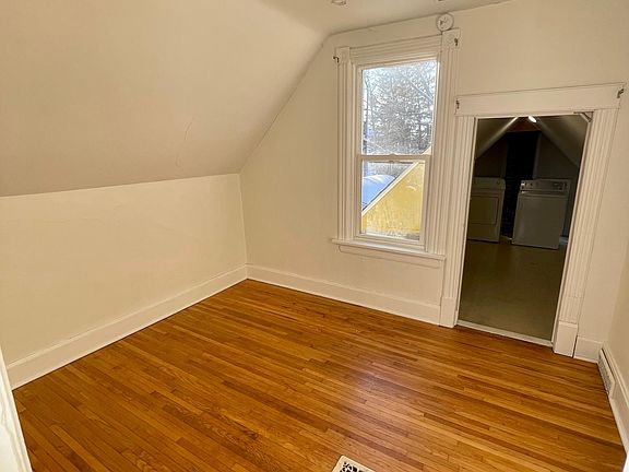 bedroom and door leading to walk in closet and laundry area