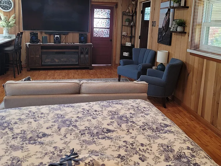 Bed area to living room area. TV and Electric fireplace will stay.