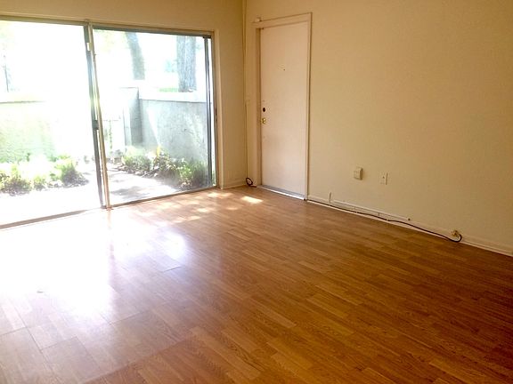 Spacious living room, with vinyl flooring, overlooking the patio