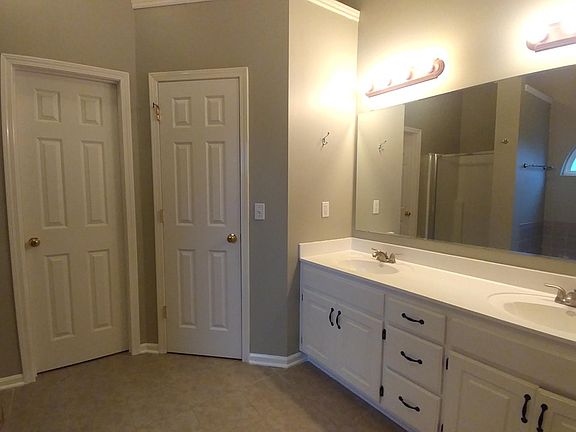 main bathroom. The picture shows two doors. One for closet and the other is for restroom. And to the left, there are shower booth and tub