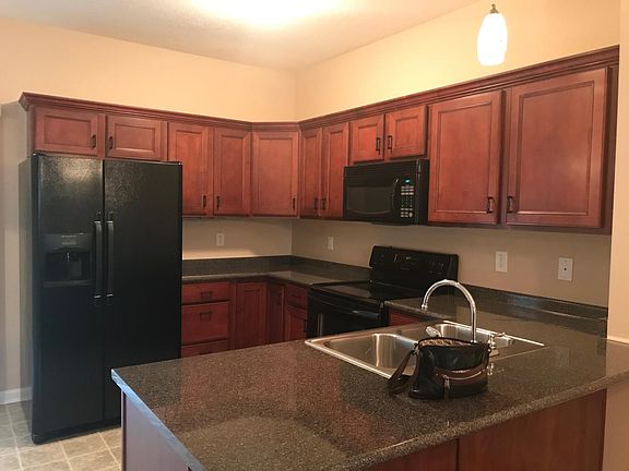 Beautiful kitchen with granite counter tops with eat at space at the end