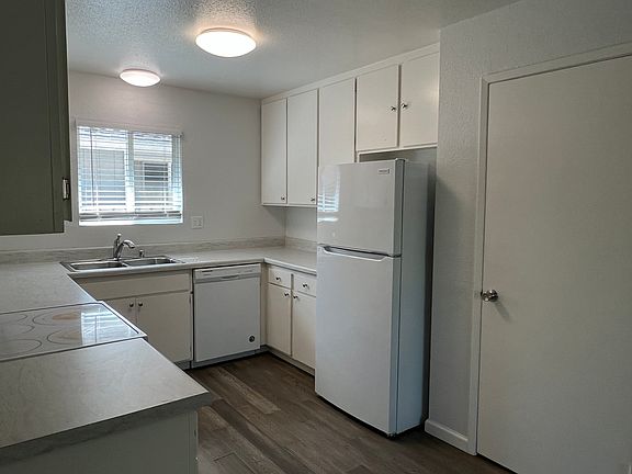 Kitchen with pantry closet to the right, newer refrigerator included