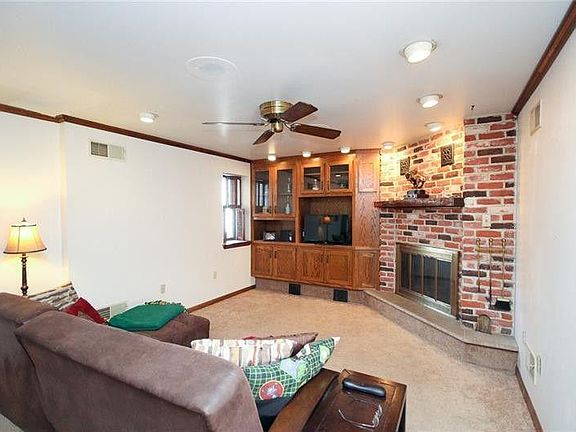 Living room with fireplace and large built in for setting up your entertainment center.