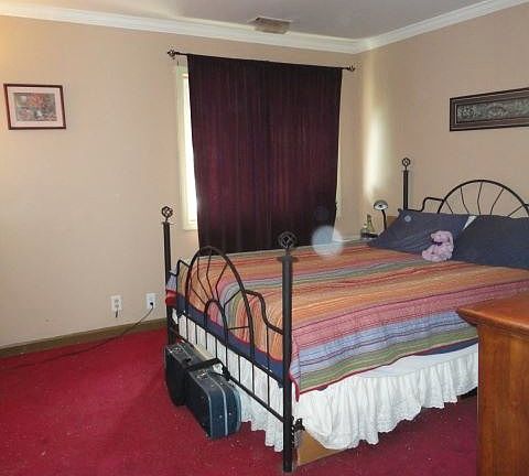 Spacious bedroom easily fits queen bed, dresser, bookcase, a