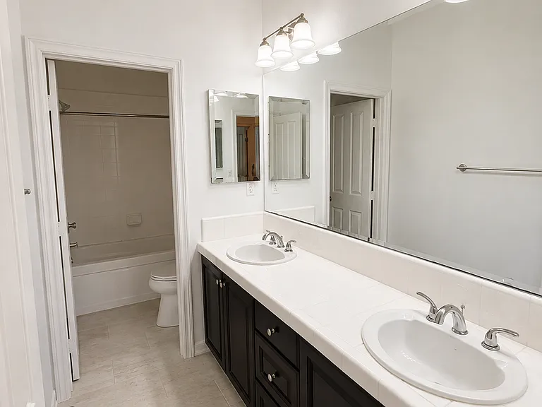 Full bathroom upstairs with dual vanity sinks