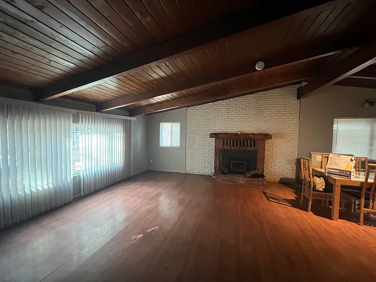 Main floor living room open to dining area and kitchen.