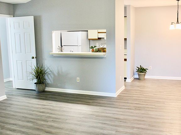 Spacious living room with brand new flooring and freshly painted throughout entire condo. High vaulted ceiling with overheadlight and fan