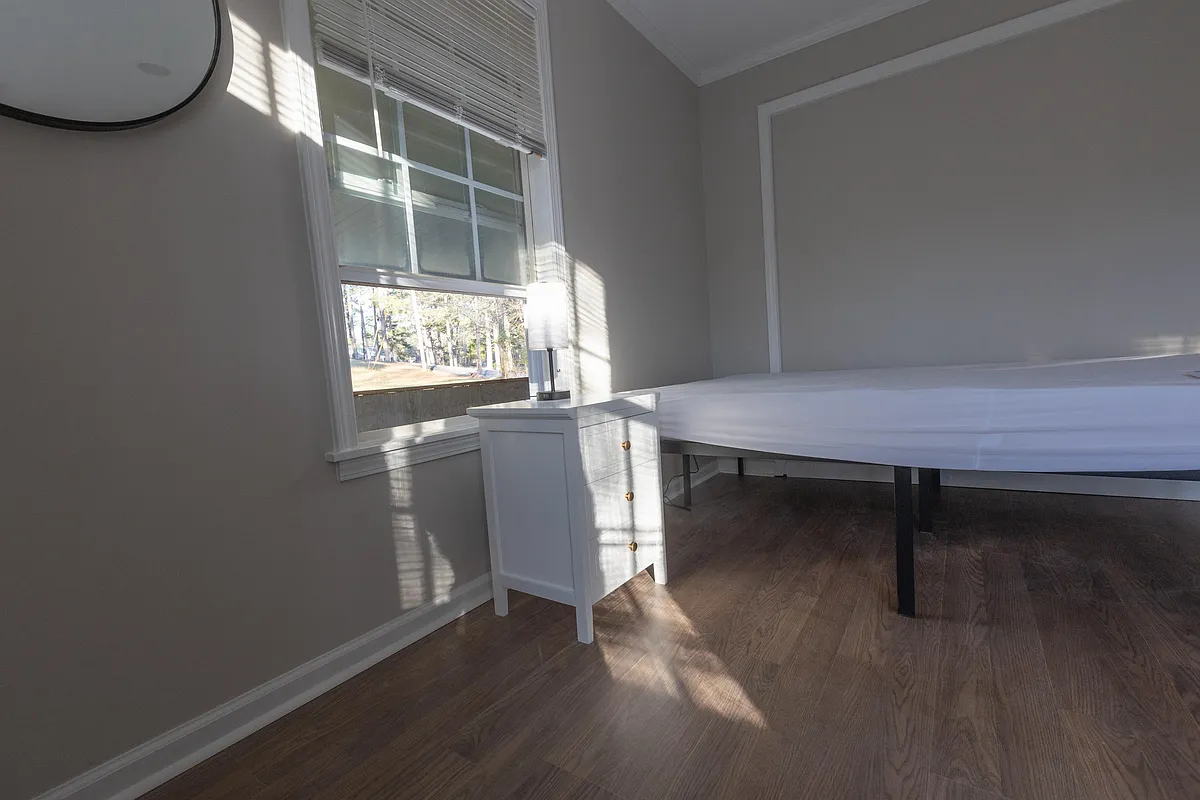View of bed and nightstand for this room. - Burnham Rd