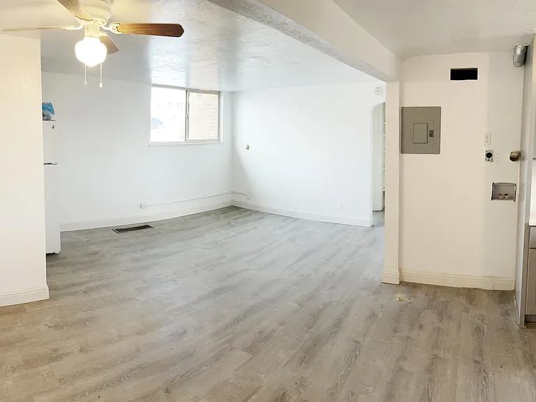 Living/dining room with large window that looks out to the front of the property