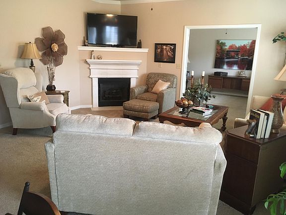 Ample living area open to dining and view into double-door open office room. Both with southern exposure windows to open courtyard.