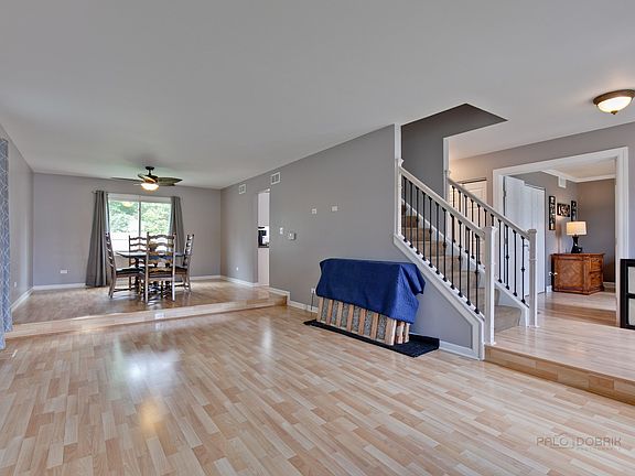 Large open living room with gleaming wood laminate floors that continue throughout the first floor.