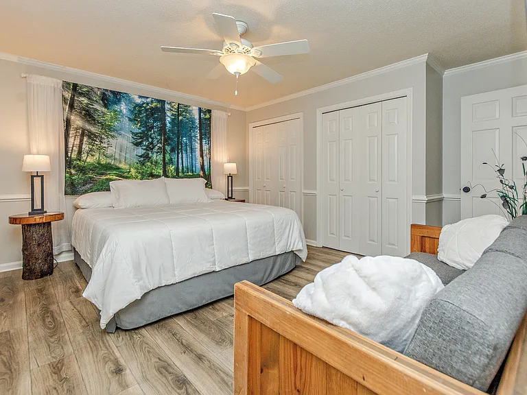 Master King Bedroom with forest light rays wall tapestry.