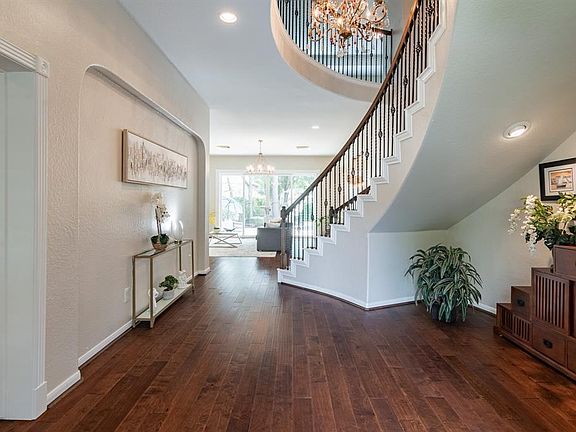 Beautiful views welcome you once stepping inside into the formal entry. Freestanding curve staircase with cove ceiling above fea