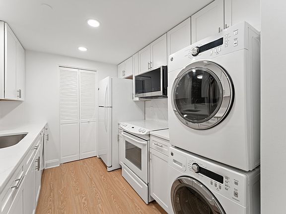 Full-size washer & dryer, new microwave, farmer's sink; dishwasher, disposal, and stove.