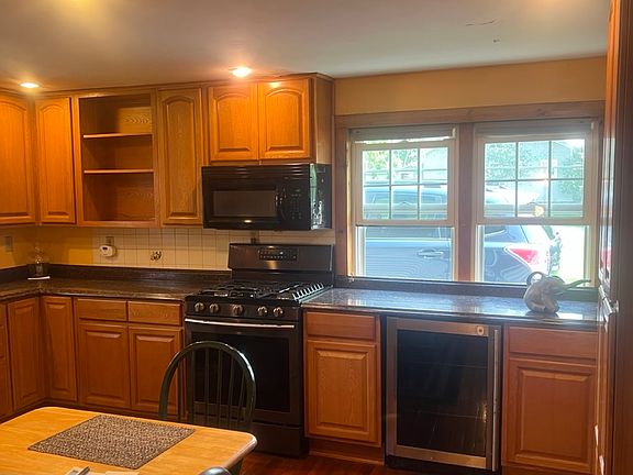 Kitchen showing the beverage cooler, Samsung gas stove, and microwave