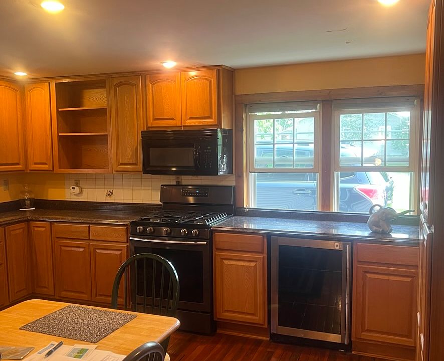 Kitchen showing the beverage cooler, Samsung gas stove, and microwave